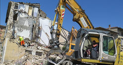 Crane and collapsed house